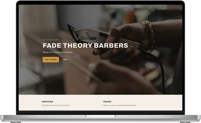 Fade Theory Barbers demo site on a laptop